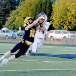 Spartan Gunner Rogers (16) and Sequim's Zeke Schmadeke (14) pull in a Forks pass for joint possession.  Joint possession goes to the offense giving Forks a first down.  (Lonnie Archibald/for Peninsula Daily News)