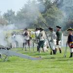 A collection of American militiamen fire upon English Redcoats during a mock skirmish at the Northwest Colonial Festival near Agnew on Saturday. The event, hosted by the George Washington Inn, featured historical displays and interpretations of life during the Revolutionary War era. (Keith Thorpe/Peninsula Daily News)