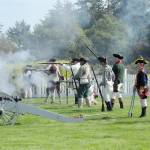 A collection of American militiamen fire upon English Redcoats during a mock skirmish at the Northwest Colonial Festival near Agnew on Saturday. The event, hosted by the George Washington Inn, featured historical displays and interpretations of life during the Revolutionary War era. (Keith Thorpe/Peninsula Daily News)
