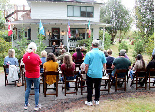 Author M.B. Thurman reads from her debut novel, Summoned, in front of the Miller Tree Inn, aka the Cullen House, during a pre-Forever Twilight in Forks event on Tuesday. M.B. (Mary Beth) and her husband Trent own the Inn. This weeks FTF Festival will also feature other authors at several other venues. (Christi Baron/Olympic Peninsula News Group)