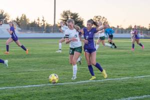 Emily Matthiessen (2)/Olympic Peninsula News Group
Port Angeles Izzy Felton, left, and Sequims Mikiah Winter jostle for possession of the ball along the sideline during the first half of the Wolves 2-1 Rainshadow Rumble girls soccer victory.