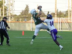 Port Angeles' Landyn Jones goes up to haul in a 35-yard pass from quarterback Parker Nickerson in the first quarter Friday night at Civic Field in Port Angeles. The catch helped lead to a touchdown pass to Ezra Townsend on the next play. (Dave Logan/for Peninsula Daily News)