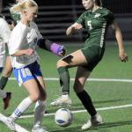 KEITH THORPE/PENINSULA DAILY NEWS Port Angeles Keds DeScala, right, fends off the defense of Olympics Emma Sagee during Thursdays match at Wally Sigmar Field in Port Angeles.