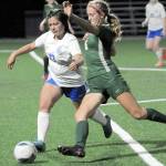 KEITH THORPE/PENINSULA DAILY NEWS Port Angeles Becca Manson, right, fights for control with Olympics Emiko Carrier-Berndt on Thursday night at Peninsula College.