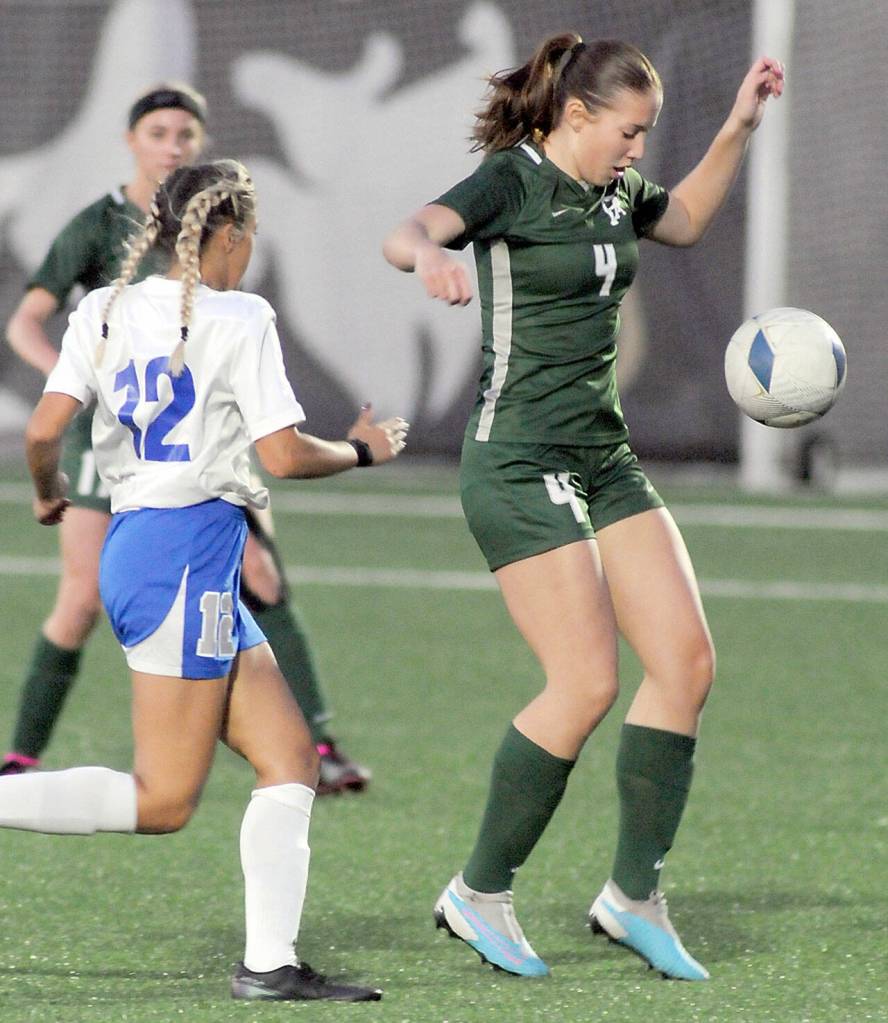 KEITH THORPE/PENINSULA DAILY NEWS Port Angeles Cayleigh Alward, right, settles a loose ball as Olympics Lili Diaz closes in during Thursdays match in Port Angeles.