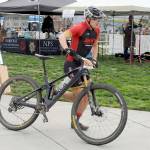 KEITH THORPE/PENINSULA DAILY NEWS Calvin Colander of Bellingham-based Team Improbability Drive heads for the handoff after finishing the mountain bike leg of Saturdays Big Hurt in Port Angeles.