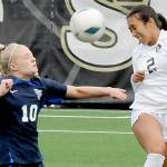 KEITH THORPE/PENINSULA DAILY NEWS
Peninsula's Briana-Jean Tanaka, right, leaps for a header in front of Bellevue's Giulia Menning on Saturday at Peninsula College in Port Angeles. Looking on from behind is Tanaka's teammate Keilee Silva.