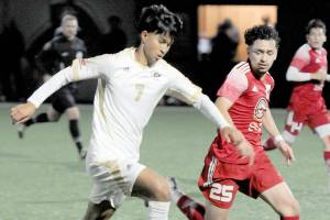 Peninsulas Matthew Enriquez, left, tries to stay ahead of the defense of Skagit Valleys Nick Kapp on Wednesday in Port Angeles. (Keith Thorpe/Peninsula Daily News)
