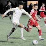 Peninsulas Matthew Enriquez, left, tries to stay ahead of the defense of Skagit Valleys Nick Kapp on Wednesday in Port Angeles. (Keith Thorpe/Peninsula Daily News)