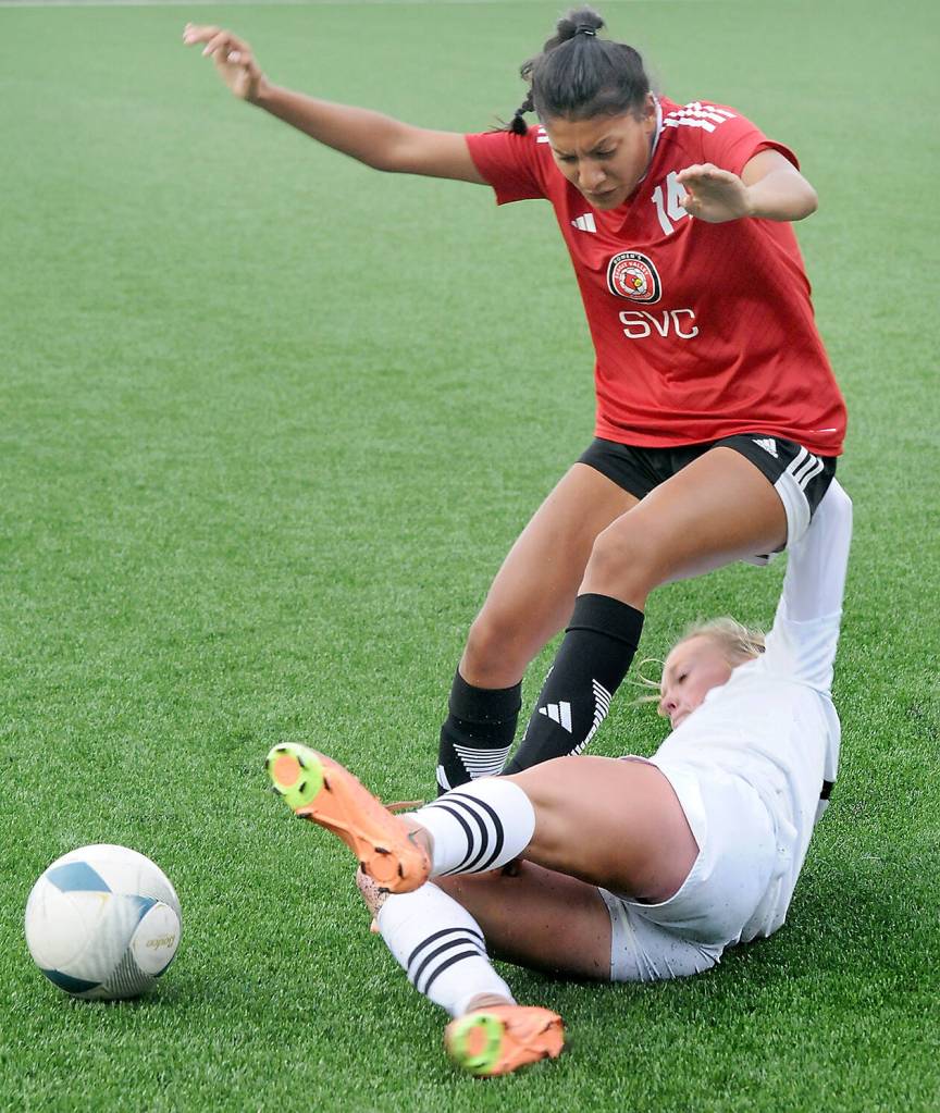 KEITH THORPE/PENINSULA DAILY NEWS 
Peninsulas Anna Petty, bottom, makes a sliding tackle on Skagit Valleys Liz Cisneros during Wednesdays match at Peninsula College.