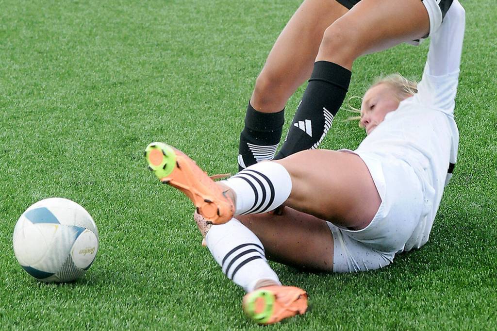 KEITH THORPE/PENINSULA DAILY NEWS
Peninsula's Anna Petty, bottom, makes a sliding tackle on Skagit Valley's Liz Cisneros during Wednesday's match at Peninsula College.
