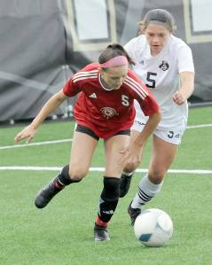 KEITH THORPE/PENINSULA DAILY NEWS Peninsulas Taya Bohenko, right, chases down Skagit Valleys Renee Wargo during Wednesdays match at Peninsula College.