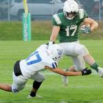 KEITH THORPE/PENINSULA DAILY NEWS
Port Angeles' Jason Hawes, right, tries to evade the tackle of Olympic's Donovan Weaver during Friday's game at Port Angeles Civic Field.