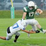 KEITH THORPE/PENINSULA DAILY NEWS Port Angeles Jason Hawes, right, tries to evade the tackle of Olympics Donovan Weaver during Fridays game at Port Angeles Civic Field.