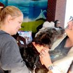Lily Alexander, left, has her mini Aussiedoodle, Wednesday, blessed by the Rev. Laura Murray of St. Andrews Episcopal Church in Port Angeles. Murray led the Blessing of the Animals on Sunday at the Gateway Transit Center. The annual blessings are performed in celebration of the Feast of St. Francis of Assisi, the 12th century patron saint of animals and the environment. (Dave Logan/for Peninsula Daily News)