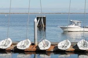 A fishing boat makes its way to the ramp at Port Angeles Boat Haven on Tuesday past a line of small sailboats belonging to the Community Boating Program for learn-to-sail classes. As the sailing season nears its end, the Port of Port Angeles plans to remove the floating docks at Boat Haven for the winter season on Oct. 16. (Keith Thorpe/Peninsula Daily News)