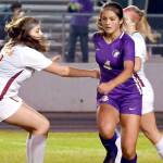 Michael Dashiell/Olympic Peninsula News Group
Sequim's Raimey Brewer looks forward after outmaneuvering Kingston's Emma Matteson for the ball during the Wolves' 4-0 win Tuesday.