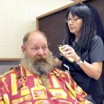 U.S. Navy veteran Brent Brant of Port Hadlock gets a haircut from Susan Gile, owner of Bennys Barbershop in Sequim, during Thursdays Port Angeles Stand Down at the Clallam County Fairgrounds. The event was designed to provide direct services and connect veterans to a variety of assistance organizations, as well as offer clothing, medical services and a meal. (Keith Thorpe/Peninsula Daily News)