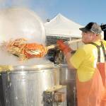 KEITH THORPE/PENINSULA DAILY NEWS
Crab cook Jacob Brown takes cooked crabs from a boiling kettle on Thursday in preparation for this weekend's Dungeness Crab and Seafood Festival in Port Angeles. The three-day event features a variety of seafood and other culinary delights, musical entertainment and other activities along the Port Angeles waterfront.