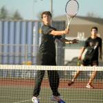 Michael Dashiell/Olympic Peninsula News Group Sequims William Hughes, front, returns a shot while doubles partner Tom Laschet looks on during the Wolves match with Kingston on Thursday.