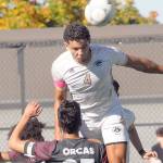 KEITH THORPE/PENINSULA DAILY NEWS
Peninsula's Fin Moutune, top, takes the header above Whatcom's Eduardo Rocha, front, and Josiah Dupree on Saturday in Port Angeles.
