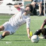 KEITH THORPE/PENINSULA DAILY NEWS
Peninsula's Tsubasa Abe, left, gets thrown off balance by a tackle by Whatcom's Christian Torres on Saturday at Peninsula College.