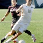 Peninsulas Nil Grau, front, works around the defense of Whatcoms Danny Rojas on Saturday at Peninsula College in Port Angeles. (Keith Thorpe/Peninsula Daily News)