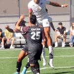 Peninsulas Fin Moutune, top, takes the header above Whatcoms Eduardo Rocha, front, and Josiah Dupree on Saturday in Port Angeles. (Keith Thorpe/Peninsula Daily News)