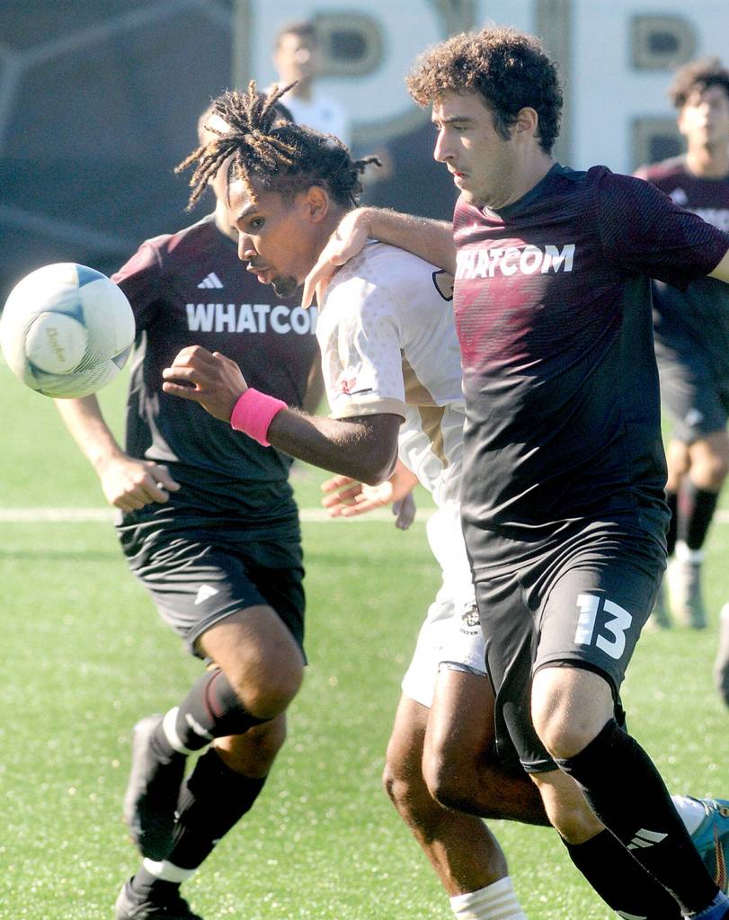 Peninsulas Abdurahim Leigh, center, squeezes between Whatcoms Francesco Plando, right, and Koren Collier during Saturdays match at Peninsula College. (Keith Thorpe/Peninsula Daily News)