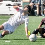 KEITH THORPE/PENINSULA DAILY NEWS
Peninsula's Tsubasa Abe, left, gets thrown off balance by a tackle by Whatcom's Christian Torres on Saturday at Peninsula College.