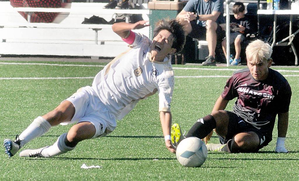 KEITH THORPE/PENINSULA DAILY NEWS
Peninsula's Tsubasa Abe, left, gets thrown off balance by a tackle by Whatcom's Christian Torres on Saturday at Peninsula College.