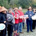 Lower Elwha Klallam tribal members sing the Salmon Song led by Jonathan Arakawa, right. More than 100 people attended the outdoor ceremony Monday near the banks of the Elwha River at the Lower Elwha Klallam Hatchery, 700 Stratton Road. The tribe has been waiting for the go-ahead to fish the Elwha like their ancestors did a century ago. The fishery will be a mix of hook-and-line and river nets, and fishing will continue until the quota of 400 has been met. (Dave Logan/for Peninsula Daily News)