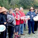 Lower Elwha Klallam tribal members sing the Salmon Song led by Jonathan Arakawa, right. More than 100 people attended the outdoor ceremony Monday near the banks of the Elwha River at the Lower Elwha Klallam Hatchery, 700 Stratton Road. The tribe has been waiting for the go-ahead to fish the Elwha like their ancestors did a century ago. The fishery will be a mix of hook-and-line and river nets, and fishing will continue until the quota of 400 has been met. (Dave Logan/for Peninsula Daily News)