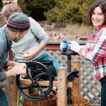 Local resident Sheana Joy Walvatne uses an apple press at the Olympic Peninsula Apple and Cider Festival in 2022.