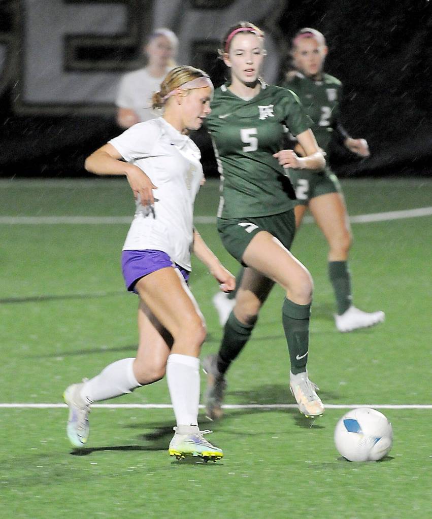 KEITH THORPE/PENINSULA DAILY NEWS Sequims Ivy Barrett, front, dribbles past Port Angeles Kedryn DeScala during Tuesdays match at Peninsula College in Port Angeles.