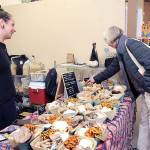 KEITH THORPE/PENINSULA DAILY NEWS
Shana Rogers of Port Angeles-based Maddie's Mushrooms, left, talks about her products as Linda Dilan of Port Angeles makes a selection on Friday at the three-day Olympic Peninsula Fungi Festival. The event, centered at the Clallam County Fairgrounds in Port Angeles with additional activities at the Dungeness River Nature Center in Sequim on Sunday, featured a variety of mycology topics and vendors, along with numerous lectures, workshops and entertainment.