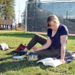 Kellie Baker of Port Angeles enjoys a warm autumn day to eat lunch with a book at Erickson Playfield in Port Angeles on Wednesday. Mostly dry conditions are forecast for much of the region through the weekend with wetter weather expected to return by early next week. (Keith Thorpe/Peninsula Daily News)