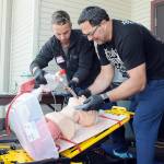 Clallam County Fire District 3 firefighter/paramedics Jeremy Church, left, and Jeff Albers practice resuscitation techniques during a training session on Thursday at Vern Burton Community Center in Port Angeles. Numerous medical personnel from fire districts 2, 3 and 4, along with the Port Angeles Fire Department and Olympic Ambulance, took part in the Difficult Airway Course featuring a variety of resuscitation situations in an event hosted by the Clallam County EMS Council. (Keith Thorpe/Peninsula Daily News)