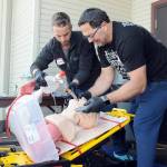 Clallam County Fire District 3 firefighter/paramedics Jeremy Church, left, and Jeff Albers practice resuscitation techniques during a training session on Thursday at Vern Burton Community Center in Port Angeles. Numerous medical personnel from fire districts 2, 3 and 4, along with the Port Angeles Fire Department and Olympic Ambulance, took part in the Difficult Airway Course featuring a variety of resuscitation situations in an event hosted by the Clallam County EMS Council. (Keith Thorpe/Peninsula Daily News)