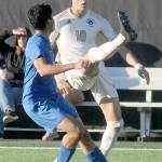 Peninsulas Nil Grau gives a high kick to keep the ball out of reach of Edmonds Enzo Buenaventura during Wednesdays match in Port Angeles. (Keith Thorpe/Peninsula Daily News)