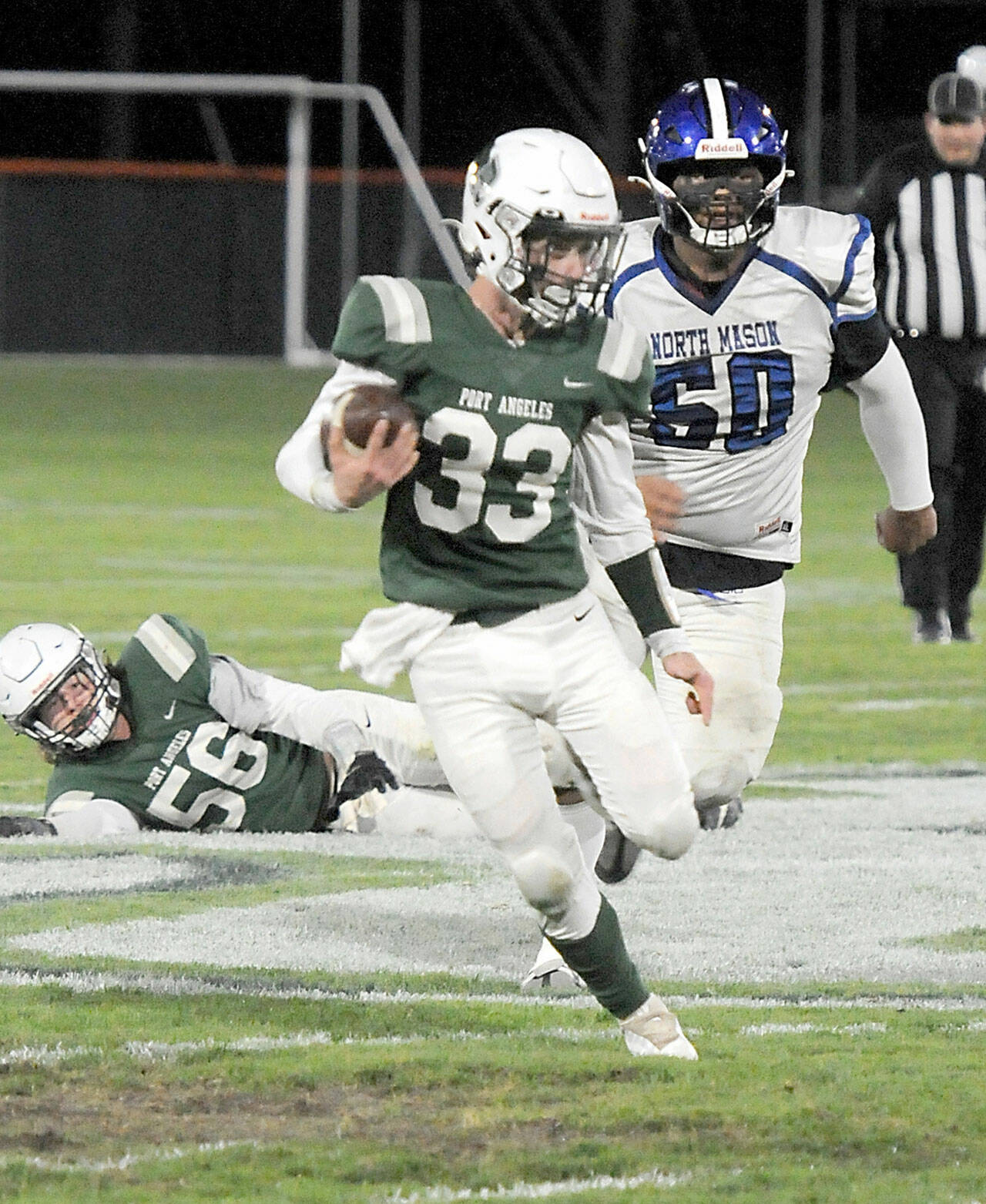 Port Angeles James Browning (33) rushes from the backfield chased by North Masons Ryan Wright as Port Angeles Tanner Flores (56) looks on from behind on Friday night in Port Angeles. (KEITH THORPE/PENINSULA DAILY NEWS)