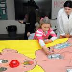 Sonnie Fountain, 8, of Sequim plays an oversized version of the Operation game under the direction of Sequim High School freshman Lillian Anderson during Saturdays Haunted Hallways holiday event at the school. Haunted Hallways featured a portion of the school set aside for a variety of Halloween games and attractions hosted by students as a benefit for the Sequim Food Bank. (Keith Thorpe/Peninsula Daily News)