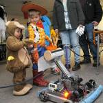 Sequim siblings Jaxson Kober, 2, and Micah Brooks, 4, receive candy offered by a robot created by students in the Sequim High School robotics program during Haunted Hallways on Saturday at the school. Haunted Hallways featured a portion of the school set aside for a variety of Halloween games and attractions hosted by students as a benefit for the Sequim Food Bank. (Keith Thorpe/Peninsula Daily News)