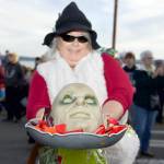 Druze Hartwell of Port Townsend holds a bowl with a mask in the middle before marching in the 27th Port Townsend Main Street Program Trick or Treat and Costume Parade in downtown Port Townsend on Tuesday. (Steve Mullensky/for Peninsula Daily News)