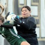 KEITH THORPE/PENINSULA DAILY NEWS
Port Angeles' Izzy Felton, front, gets tangled in the box with Renton goalkeeper Zitlaly Valeriano-Reyes during Tuesday's bidistrict playoff at Wally Sigmar Field in Port Angeles.