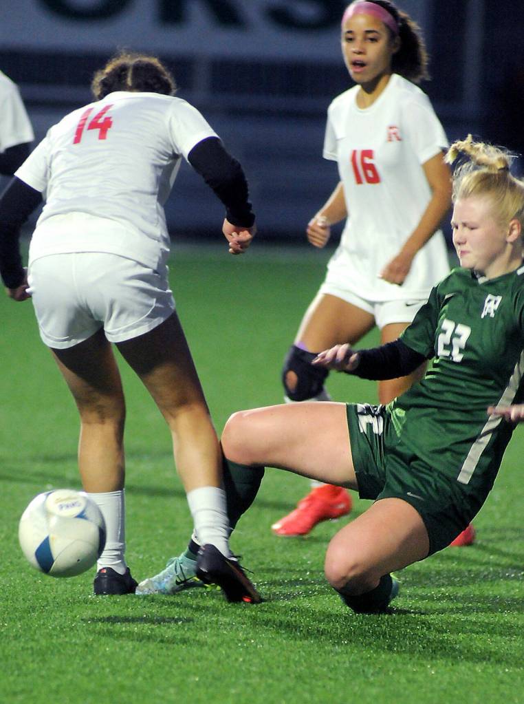 KEITH THORPE/PENINSULA DAILY NEWS
Port Angeles' Paige Mason, right, makes a sliding tackle on Renton's Madison Hull, left as Renton's Laila Vieira during Tuesday's match at Peninsula College.