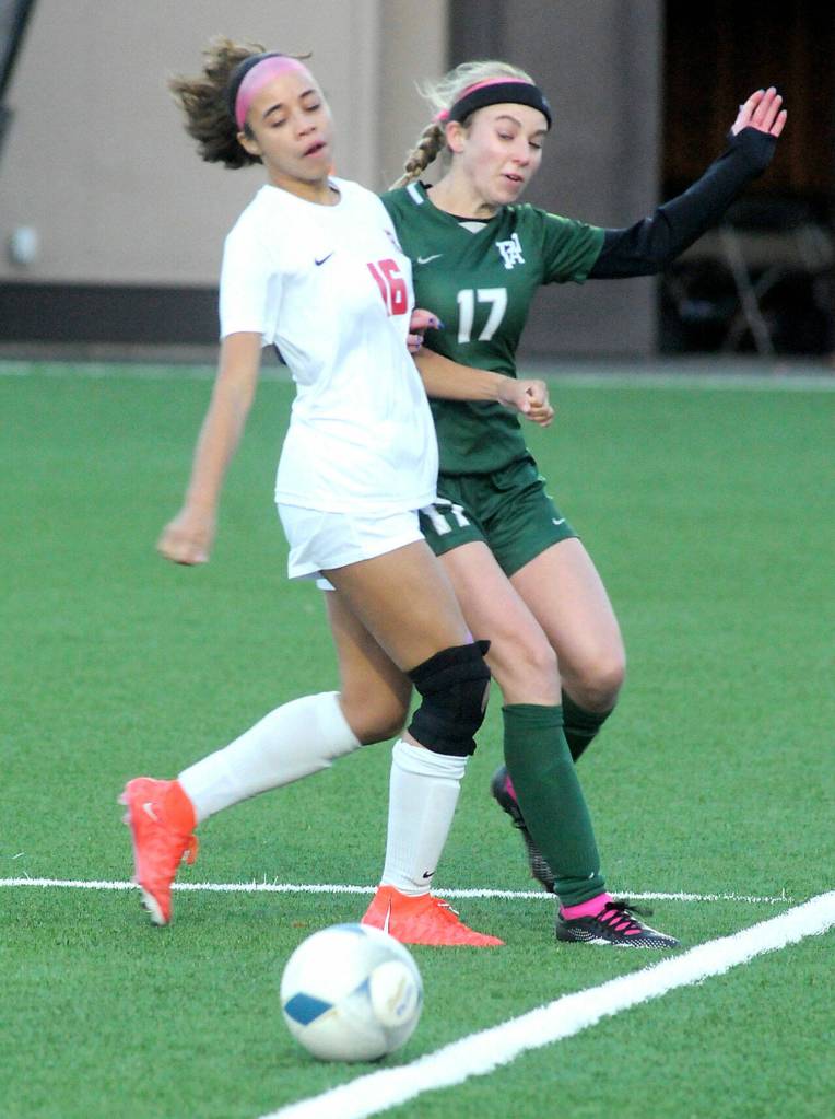 KEITH THORPE/PENINSULA DAILY NEWS Port Angeless Ava-Anne Sheahan, right, pushes off of Rentons Laila Vieira as the ball rolls out of bounds on Thursday evening in Port Angeles.