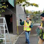 KEITH THORPE/PENINSULA DAILY NEWS
Tim Crowley, left, and Frank Bruni, members of the Olympic Kiwanis Club, string Christmas lights on a street-side tree on Friday in downtown Port Angeles. Members of the club take on the annual task of adorning trees and poles in the downtown area with lights with reimbursement from the Port Angeles Downtown Association.