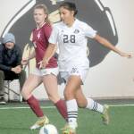 KEITH THORPE/PENINSULA DAILY NEWS
Peninsula's Disidree Dutra, front, slips past the defense of North Idaho's Faith George on Saturday at Wally Sigmar Field.