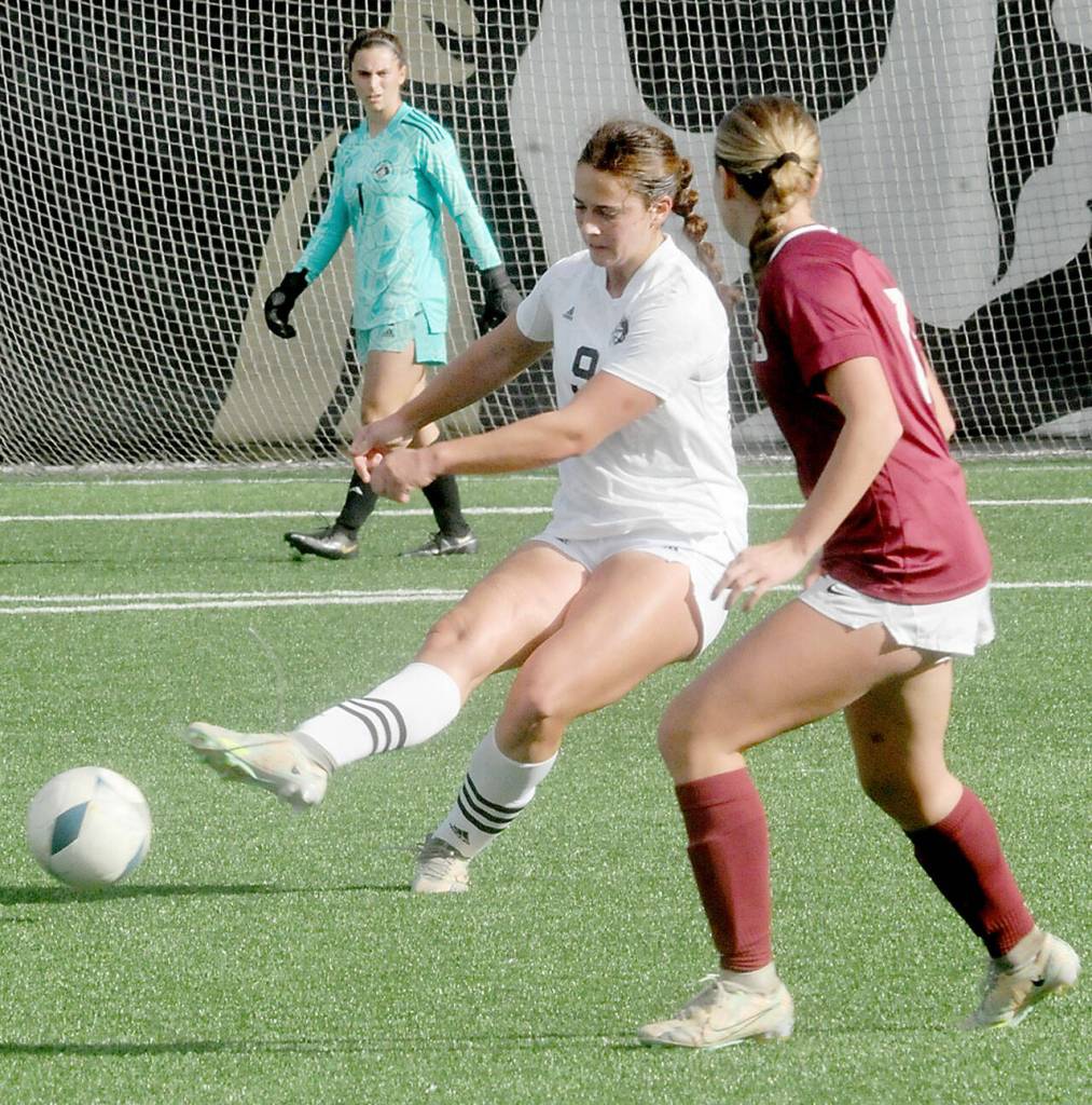 Peninsulas Lauren La Fountain, center, passes past North Idahos Addison Stoddard on Saturday in Port Angeles. (Keith Thorpe/Peninsula Daily News)